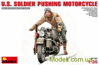 Американский солдат толкающий мотоцикл
